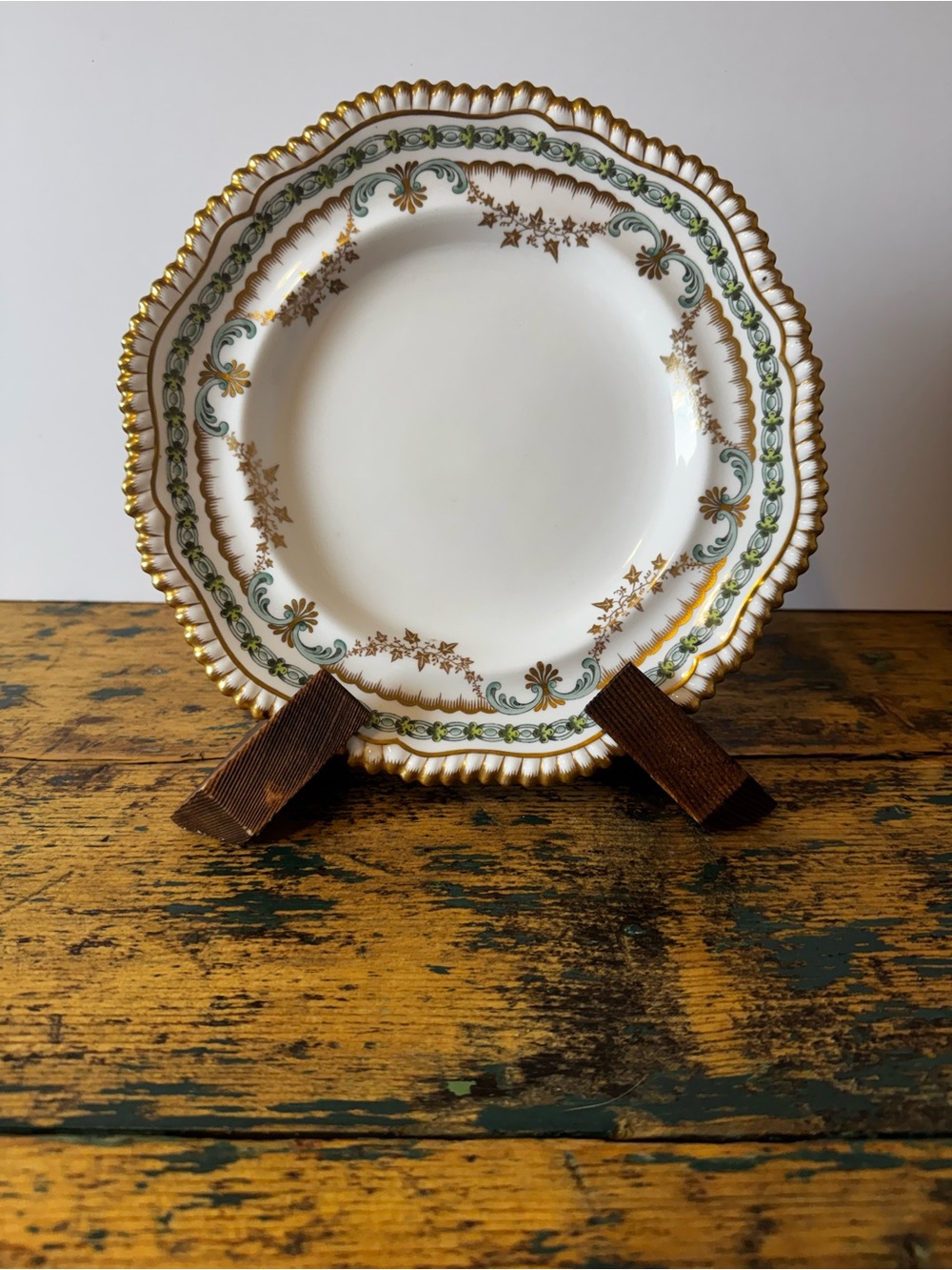 White Porcelain Dinner Plate with Gold Rim and Green Scroll Accents